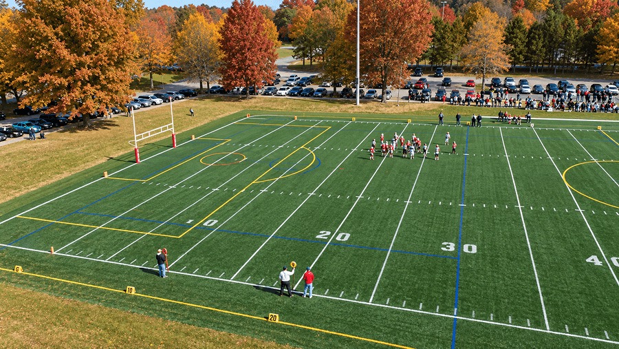 Football practice on a turf field