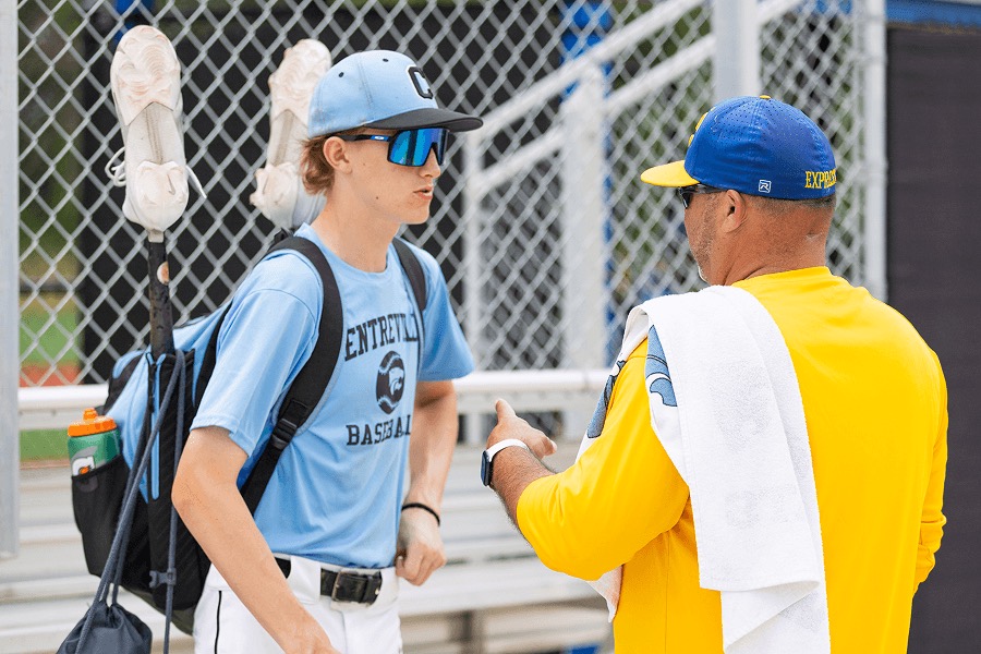Coach talking with a young baseball player