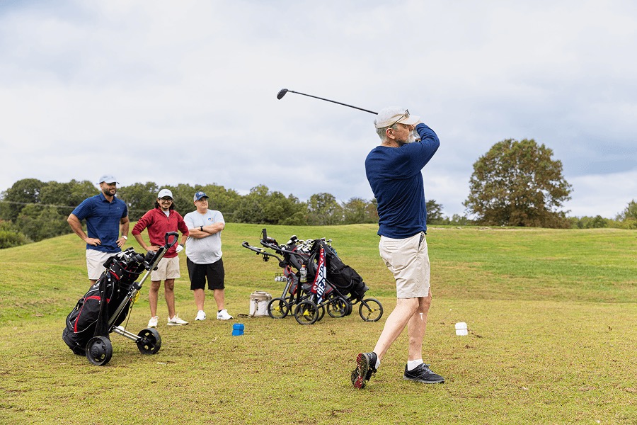 Golfer teeing off