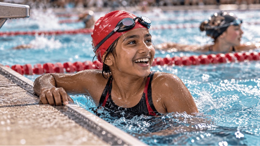 Swimmer smiling at the wall after a race